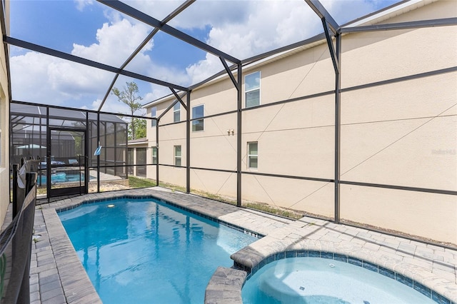 1809 Tropical Palms Cir, Kissimmee, FL 34747 - view of swimming pool featuring a patio area, glass enclosure, and a pool with connected hot tub