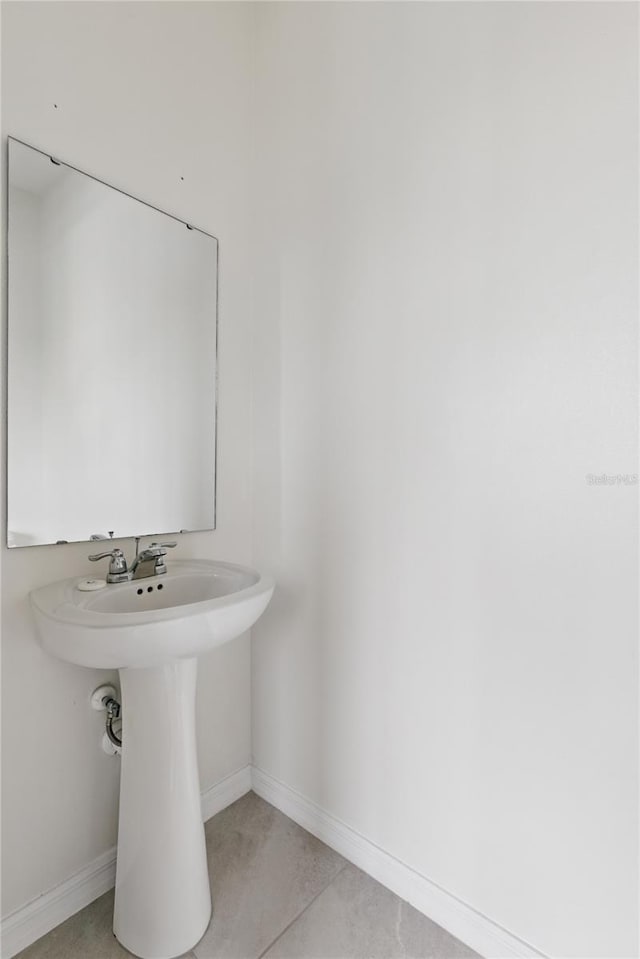 1809 Tropical Palms Cir, Kissimmee, FL 34747 - bathroom featuring baseboards and tile patterned floors