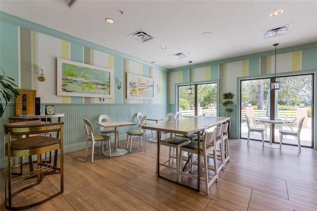 1809 Tropical Palms Cir, Kissimmee, FL 34747 - dining area with wainscoting, wallpapered walls, recessed lighting, and wood finished floors