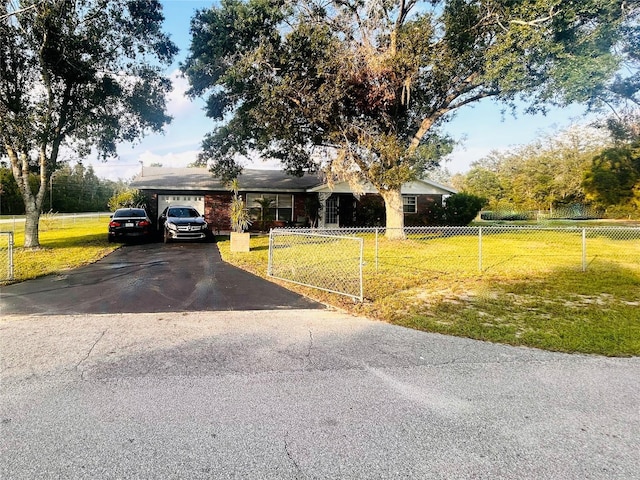 2430 N Dunwoodie Rd, Avon Park, FL 33825 - ranch-style house with asphalt driveway and a garage