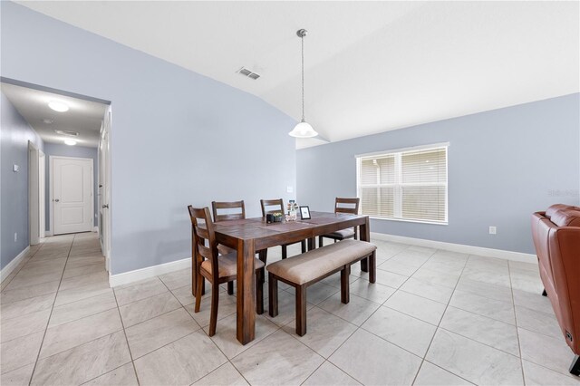 236 Miles Ct, Davenport, FL 33837 - dining room with lofted ceiling, light tile patterned floors, and baseboards
