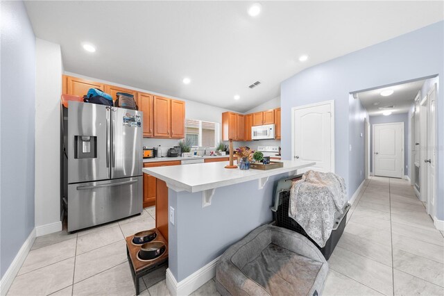 236 Miles Ct, Davenport, FL 33837 - kitchen with stainless steel fridge with ice dispenser, white microwave, lofted ceiling, light countertops, and stove