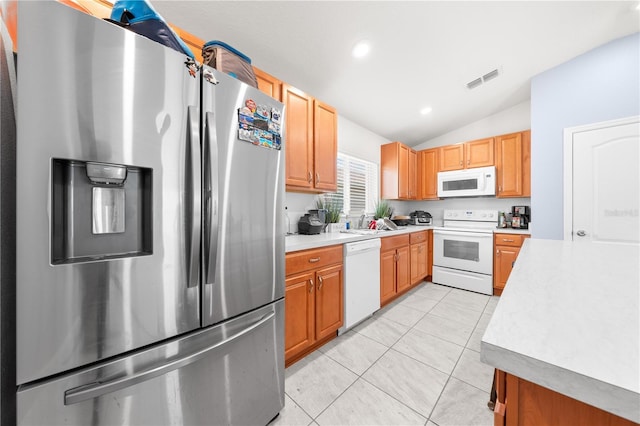 236 Miles Ct, Davenport, FL 33837 - kitchen with white appliances, lofted ceiling, light countertops, light tile patterned floors, and recessed lighting