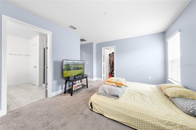 236 Miles Ct, Davenport, FL 33837 - bedroom with a walk in closet, baseboards, carpet, and a closet