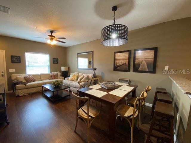 5370 Diplomat Ct Unit 107, Kissimmee, FL 34746 - dining room featuring healthy amount of natural light, dark wood-type flooring, ceiling fan, and baseboards