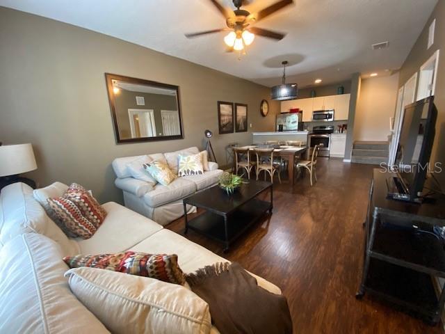 5370 Diplomat Ct Unit 107, Kissimmee, FL 34746 - living area featuring wood finished floors and a ceiling fan