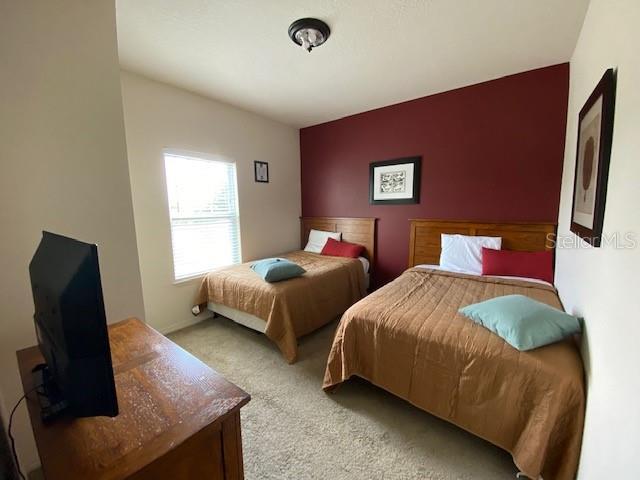 5370 Diplomat Ct Unit 107, Kissimmee, FL 34746 - bedroom with light colored carpet