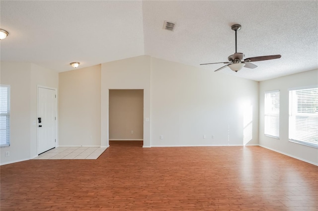 11212 3rd Ave E, Bradenton, FL 34212 - unfurnished room with light wood-style flooring, a ceiling fan, baseboards, a textured ceiling, and vaulted ceiling
