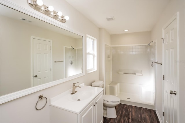 11212 3rd Ave E, Bradenton, FL 34212 - full bathroom with vanity, toilet, a shower, and wood finished floors