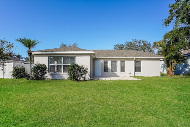 11212 3rd Ave E, Bradenton, FL 34212 - rear view of house with stucco siding, a lawn, and a patio