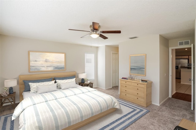 11212 3rd Ave E, Bradenton, FL 34212 - bedroom with stainless steel refrigerator with ice dispenser, light carpet, baseboards, and ceiling fan