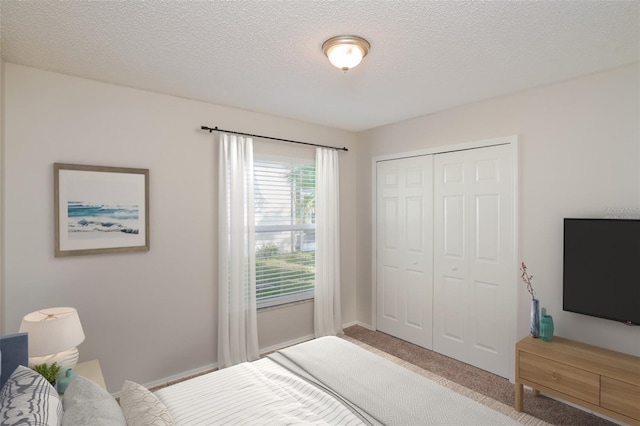 11212 3rd Ave E, Bradenton, FL 34212 - carpeted bedroom with a closet, a textured ceiling, and baseboards