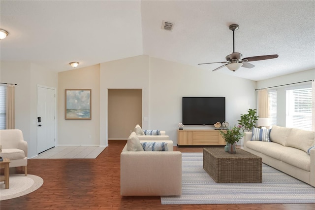 11212 3rd Ave E, Bradenton, FL 34212 - living room featuring lofted ceiling, ceiling fan, wood finished floors, and baseboards