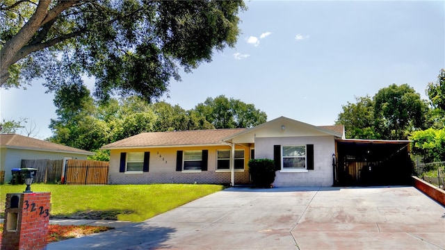 3223 Dragoon Pl, Orlando, FL 32818 - ranch-style home featuring concrete driveway and a carport