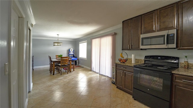 3223 Dragoon Pl, Orlando, FL 32818 - kitchen with stainless steel microwave, black electric range oven, crown molding, dark brown cabinets, and light stone counters