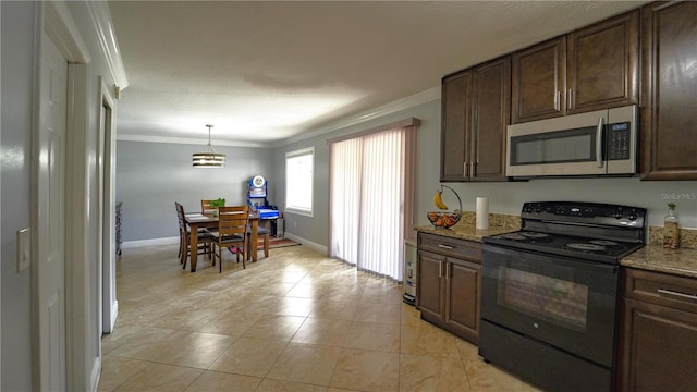 3223 Dragoon Pl, Orlando, FL 32818 - kitchen with stainless steel microwave, black range with electric cooktop, ornamental molding, dark brown cabinets, and light stone countertops