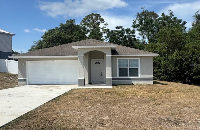 1206 Beechdale Ct, Deltona, FL 32725 - view of front of home featuring an attached garage, concrete driveway, stucco siding, and roof with shingles
