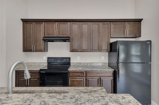 1206 Beechdale Ct, Deltona, FL 32725 - kitchen featuring black appliances, under cabinet range hood, dark brown cabinetry, a sink, and light stone countertops