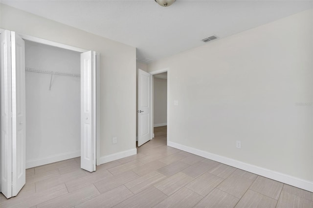 1206 Beechdale Ct, Deltona, FL 32725 - unfurnished bedroom featuring baseboards, wood finish floors, and a closet