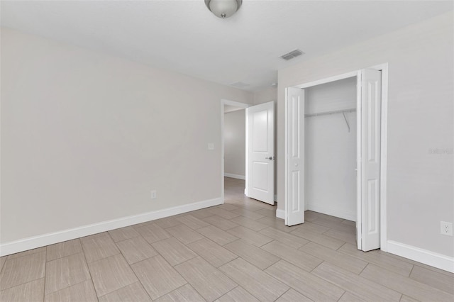 1206 Beechdale Ct, Deltona, FL 32725 - unfurnished bedroom with baseboards, a closet, and wood finish floors