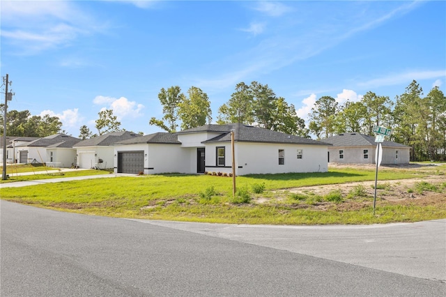 3749 SW 131st St, Ocala, FL 34473 - view of front facade featuring an attached garage, concrete driveway, stucco siding, and a front lawn