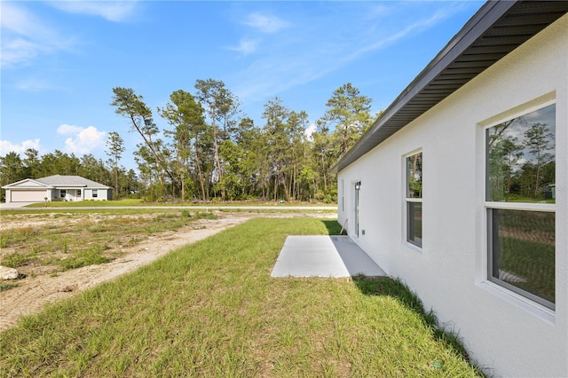 3749 SW 131st St, Ocala, FL 34473 - view of green lawn with a patio