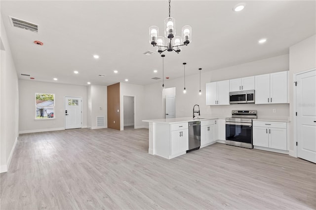 3749 SW 131st St, Ocala, FL 34473 - kitchen with stainless steel appliances, a peninsula, open floor plan, white cabinets, and recessed lighting