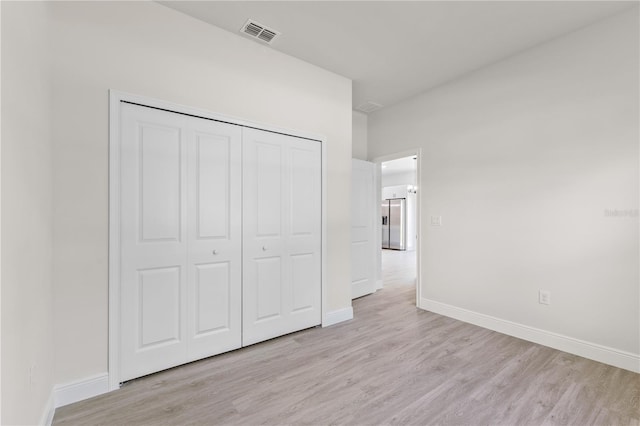 3749 SW 131st St, Ocala, FL 34473 - unfurnished bedroom with light wood finished floors, baseboards, and a closet
