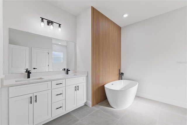 3749 SW 131st St, Ocala, FL 34473 - bathroom featuring double vanity, a freestanding bath, tile patterned floors, and baseboards