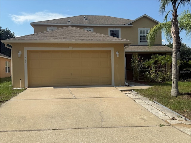 436 Hammerstone Ave, Haines City, FL 33844 - traditional-style house featuring stucco siding, driveway, and a garage