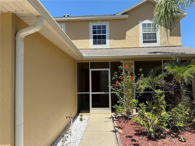 436 Hammerstone Ave, Haines City, FL 33844 - property entrance with stucco siding and a shingled roof