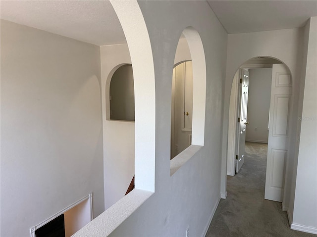 436 Hammerstone Ave, Haines City, FL 33844 - hall with carpet floors, baseboards, and arched walkways