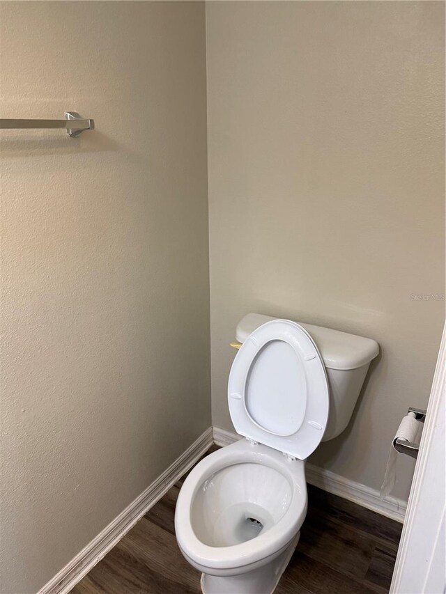 436 Hammerstone Ave, Haines City, FL 33844 - bathroom featuring toilet, wood finished floors, and baseboards