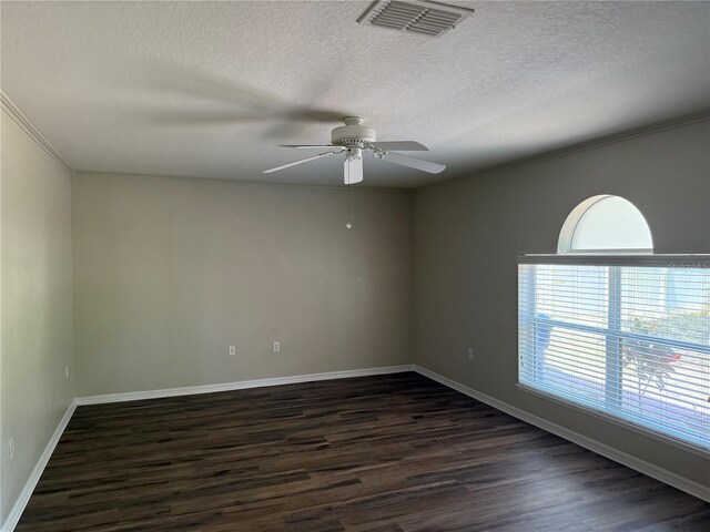 436 Hammerstone Ave, Haines City, FL 33844 - empty room with a ceiling fan, dark wood-type flooring, a textured ceiling, baseboards, and ornamental molding