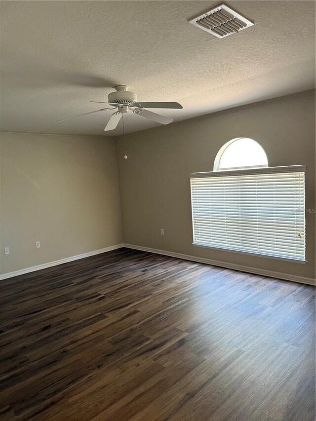 436 Hammerstone Ave, Haines City, FL 33844 - spare room featuring dark wood-type flooring, baseboards, a ceiling fan, and a textured ceiling