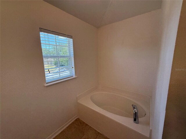 436 Hammerstone Ave, Haines City, FL 33844 - bathroom with a garden tub and baseboards