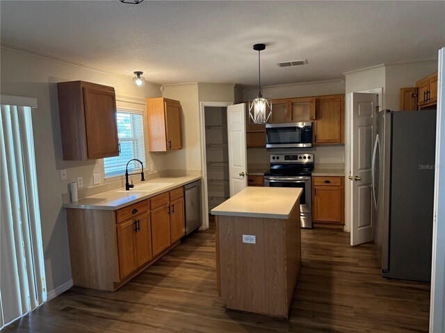 436 Hammerstone Ave, Haines City, FL 33844 - kitchen with appliances with stainless steel finishes, dark wood-type flooring, a sink, ornamental molding, and a kitchen island