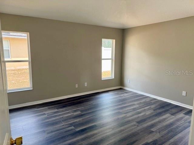 307 Dalton Ct, Davenport, FL 33897 - spare room with dark wood-style floors and baseboards
