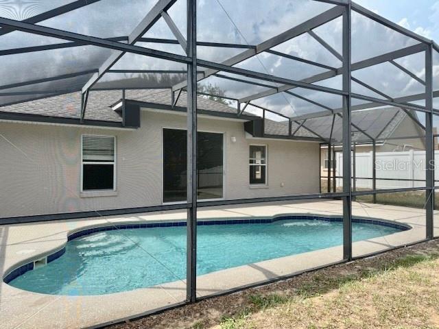 307 Dalton Ct, Davenport, FL 33897 - swimming pool with a lanai and a patio