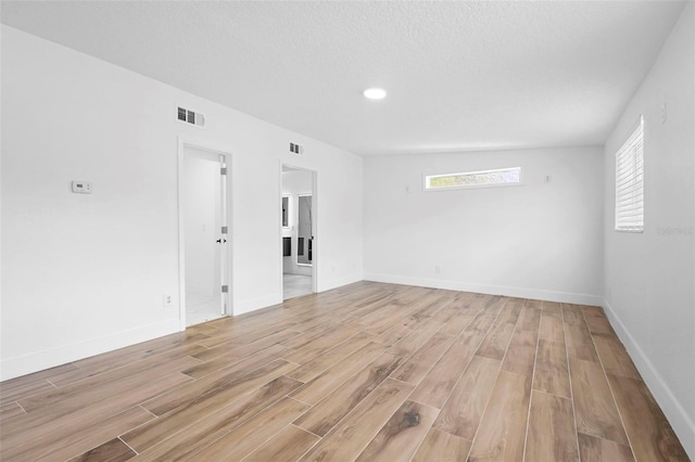 1511 E Horatio Ave, Maitland, FL 32751 - empty room featuring light wood finished floors, baseboards, recessed lighting, and a textured ceiling