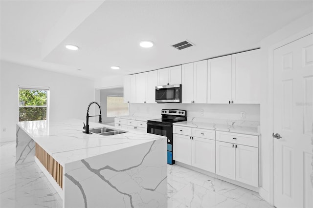 1511 E Horatio Ave, Maitland, FL 32751 - kitchen with electric stove, stainless steel microwave, a sink, light marble finish floors, and white cabinetry