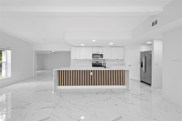 1511 E Horatio Ave, Maitland, FL 32751 - kitchen featuring appliances with stainless steel finishes, white cabinetry, light countertops, light marble finish flooring, and recessed lighting