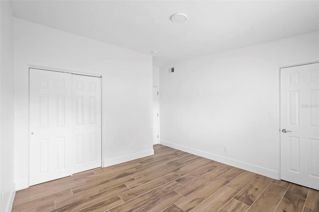 1511 E Horatio Ave, Maitland, FL 32751 - unfurnished bedroom featuring wood tiled floors, a closet, and baseboards