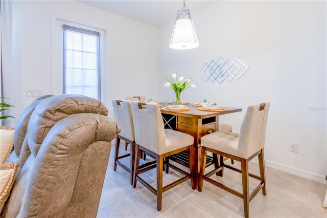 665 Longboat Dr, Davenport, FL 33896 - dining space with baseboards and light tile patterned flooring