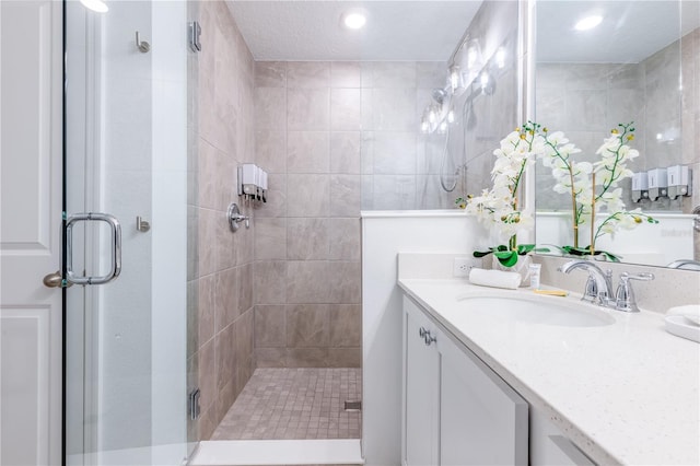 665 Longboat Dr, Davenport, FL 33896 - bathroom featuring a shower stall, vanity, and recessed lighting