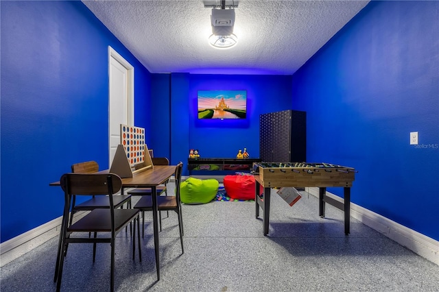 665 Longboat Dr, Davenport, FL 33896 - playroom featuring a textured ceiling, baseboards, and speckled floor
