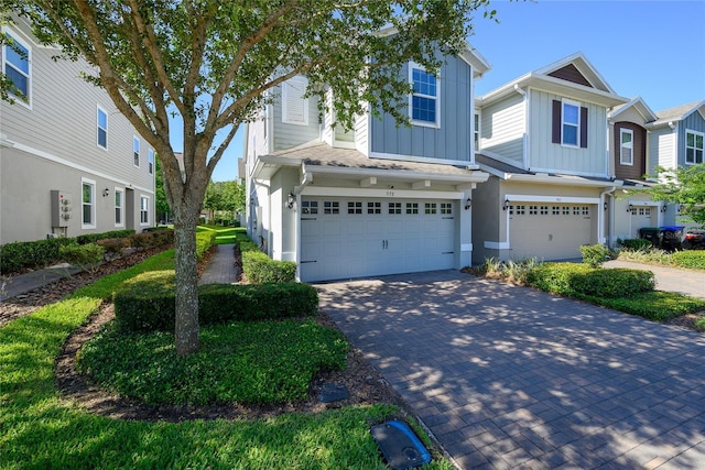 978 E 10th St, Apopka, FL 32703 - multi unit property featuring board and batten siding, an attached garage, and decorative driveway