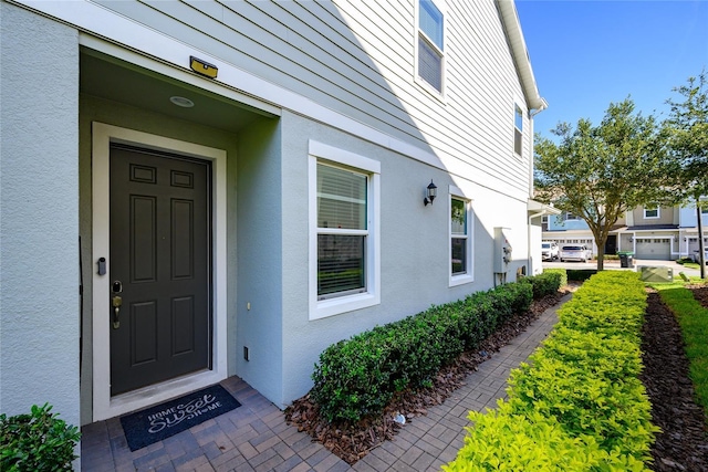 978 E 10th St, Apopka, FL 32703 - view of exterior entry with stucco siding