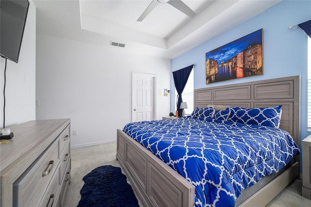 978 E 10th St, Apopka, FL 32703 - bedroom with light carpet, a raised ceiling, ceiling fan, and baseboards