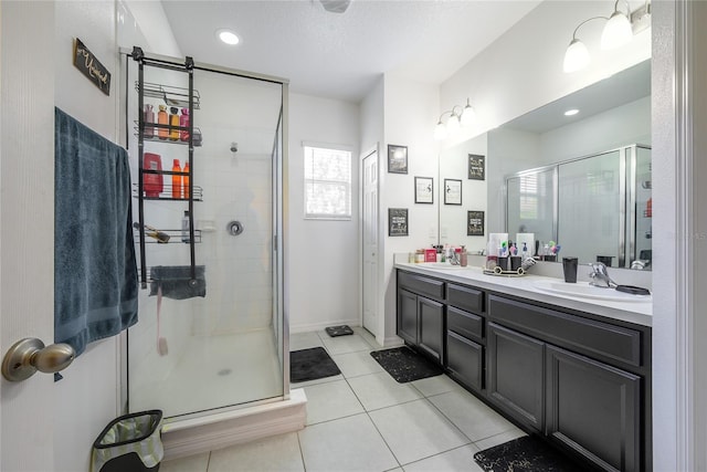 978 E 10th St, Apopka, FL 32703 - full bathroom with a stall shower, double vanity, tile patterned floors, baseboards, and recessed lighting